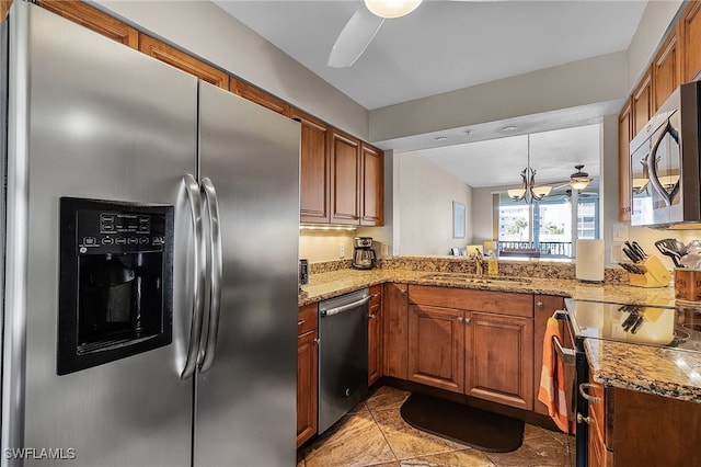 kitchen featuring light stone counters, sink, light tile patterned floors, and appliances with stainless steel finishes