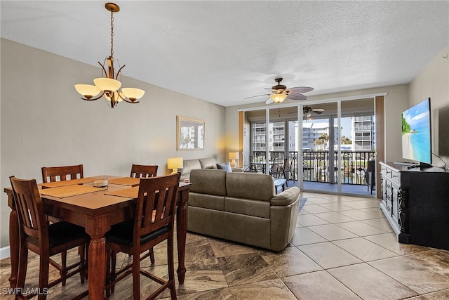 dining area featuring ceiling fan with notable chandelier and a textured ceiling