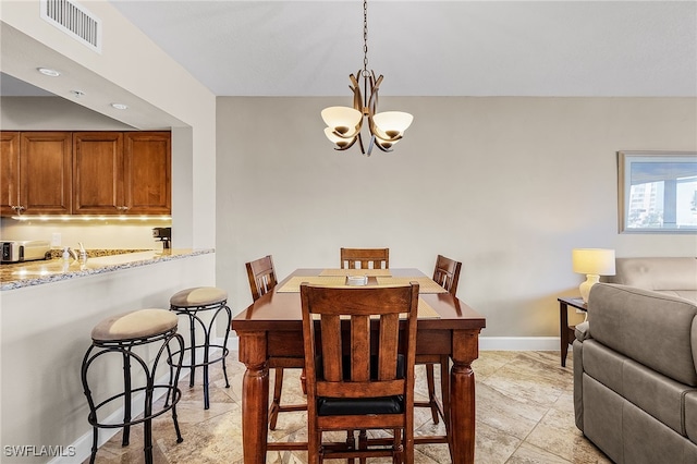 dining space with an inviting chandelier