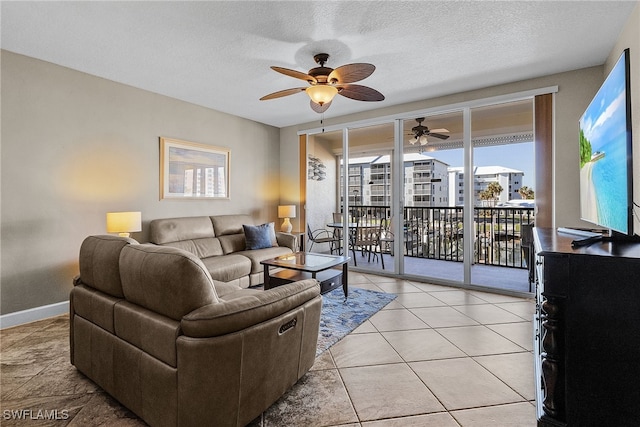 living room with light tile patterned floors, a textured ceiling, and ceiling fan