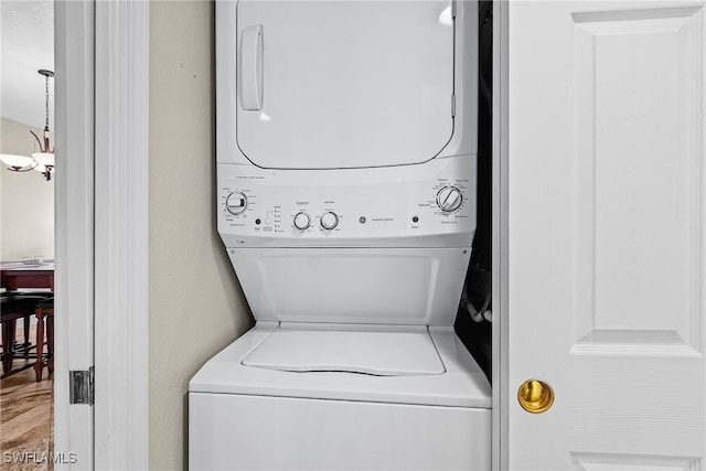 washroom featuring stacked washer and dryer