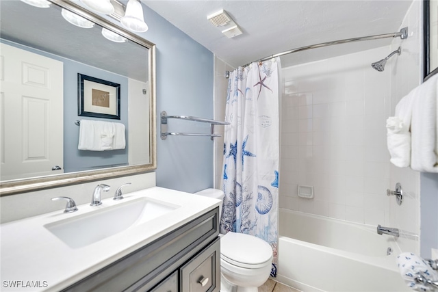 full bathroom with tile patterned flooring, shower / tub combo with curtain, vanity, and toilet