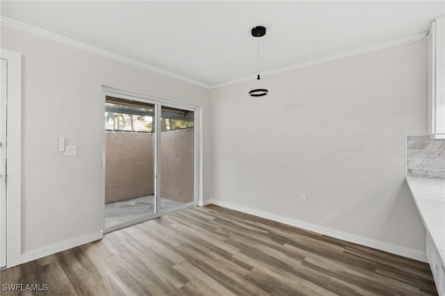 interior space featuring wood-type flooring and crown molding