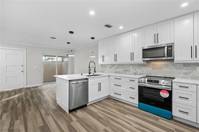 kitchen featuring white cabinetry, kitchen peninsula, and appliances with stainless steel finishes