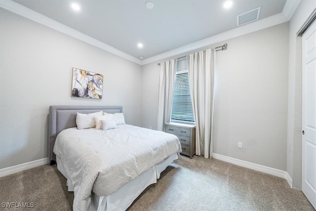 carpeted bedroom featuring crown molding