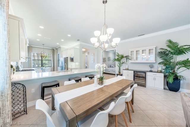 tiled dining space with wine cooler, crown molding, sink, and a notable chandelier