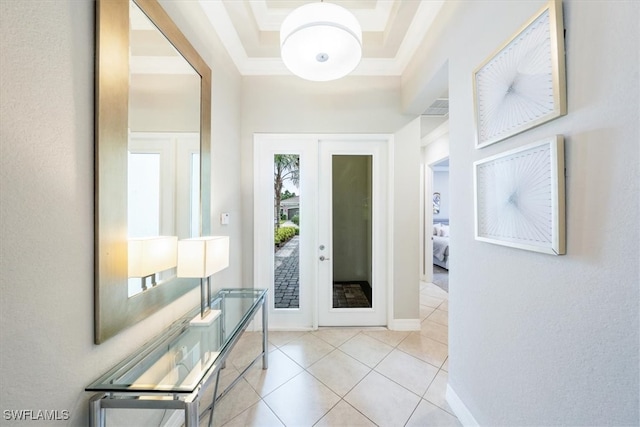 doorway to outside featuring french doors, a tray ceiling, and light tile patterned floors