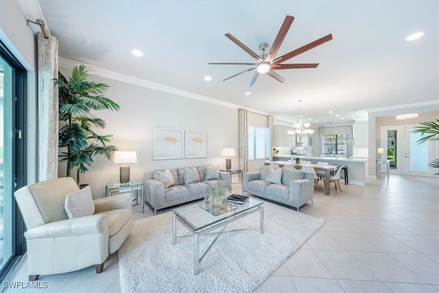 living room featuring ceiling fan with notable chandelier, ornamental molding, and light tile patterned floors