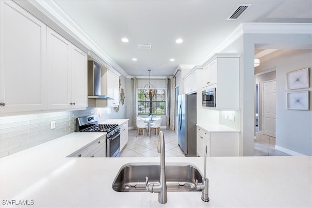 kitchen with white cabinetry, sink, wall chimney exhaust hood, and appliances with stainless steel finishes