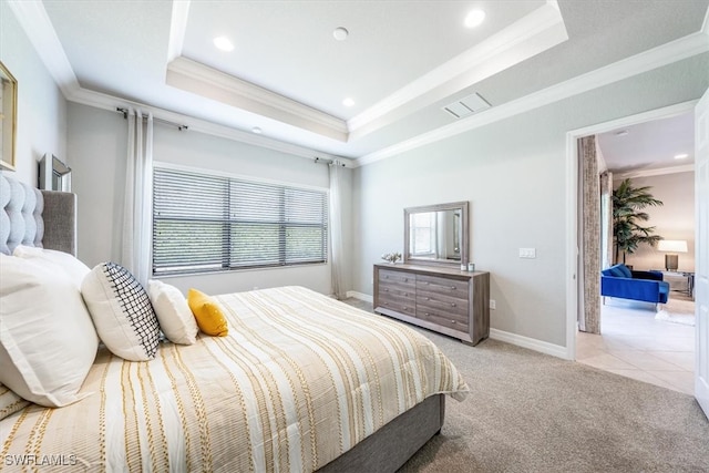 bedroom with ornamental molding, light carpet, and a tray ceiling