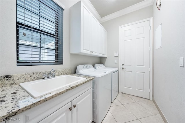 washroom with cabinets, washer and clothes dryer, crown molding, sink, and light tile patterned flooring