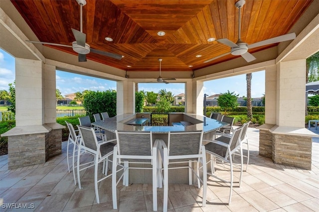 view of patio / terrace featuring ceiling fan and an outdoor bar