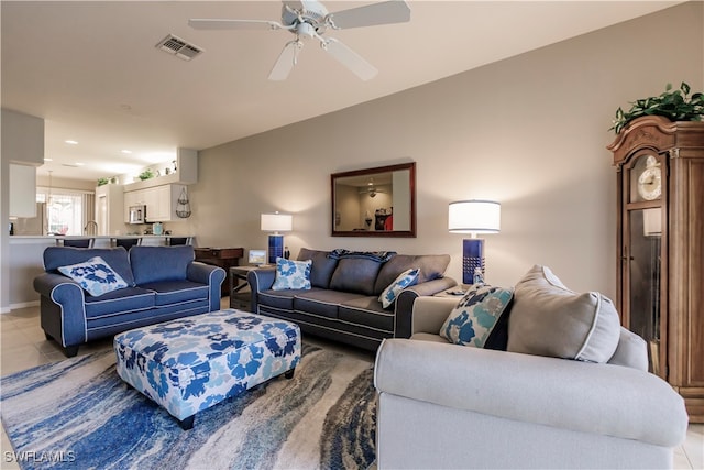 tiled living room with ceiling fan