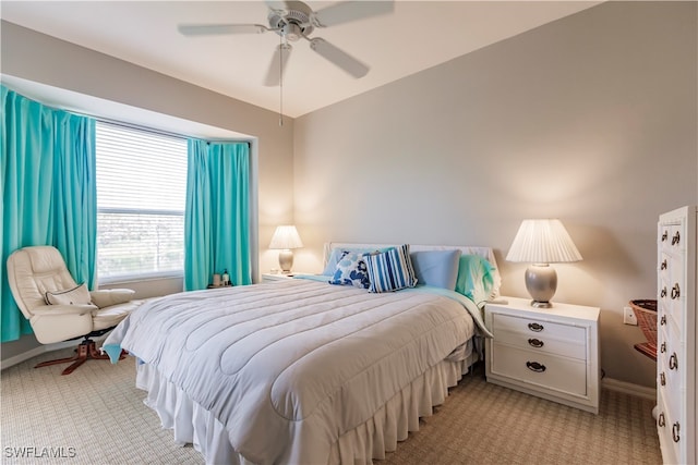 bedroom featuring ceiling fan and light carpet