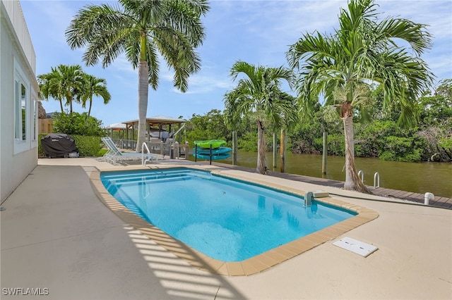 view of swimming pool with a patio area and a water view