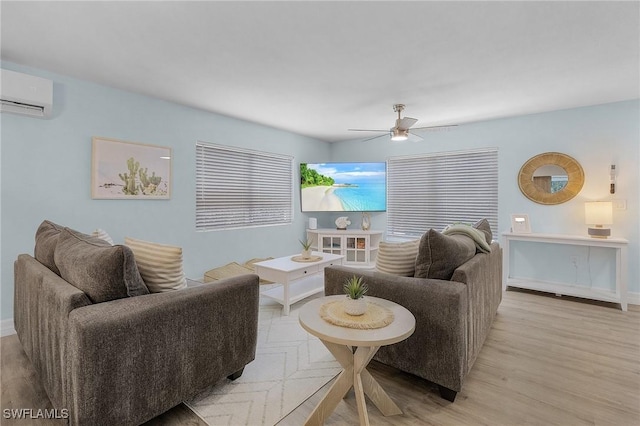 living room featuring ceiling fan, a wall mounted air conditioner, and light wood-type flooring