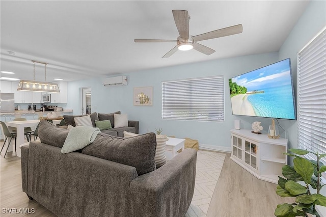 living room with ceiling fan, light parquet flooring, and a wall unit AC