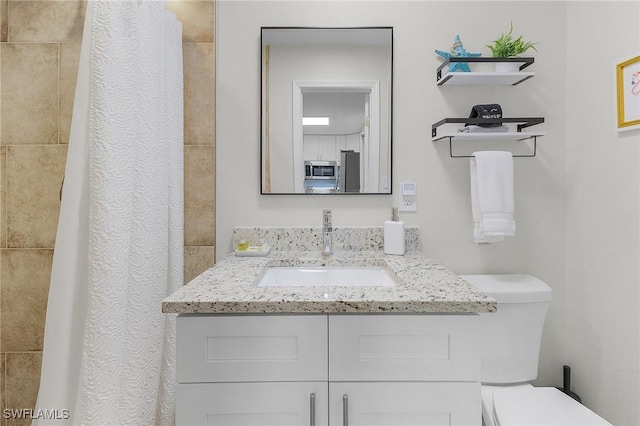 bathroom featuring vanity and toilet