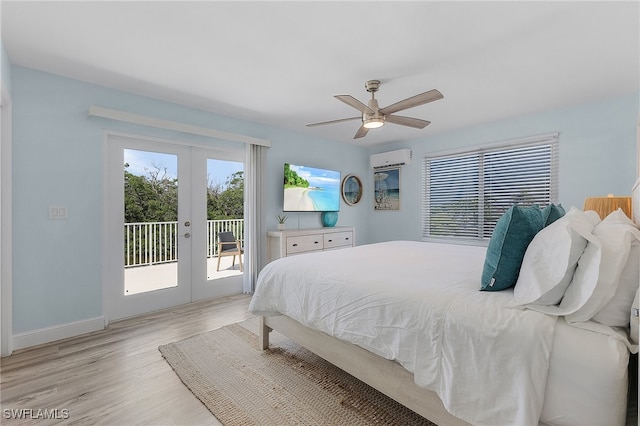 bedroom with access to outside, french doors, an AC wall unit, ceiling fan, and light wood-type flooring