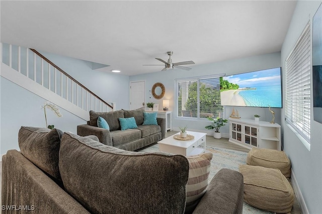 living room with light hardwood / wood-style floors and ceiling fan