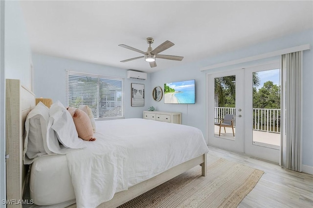 bedroom with french doors, a wall mounted air conditioner, light hardwood / wood-style flooring, access to outside, and ceiling fan