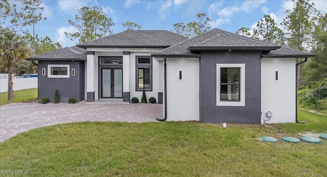 prairie-style home featuring a patio area and a front lawn