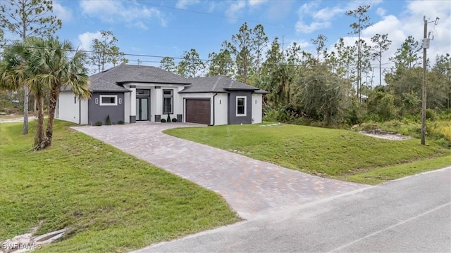 view of front of house featuring a front yard and a garage