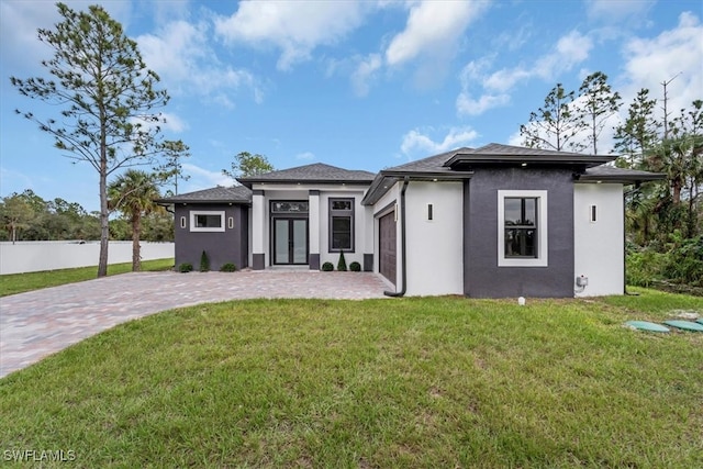 view of front of home featuring a garage and a front lawn