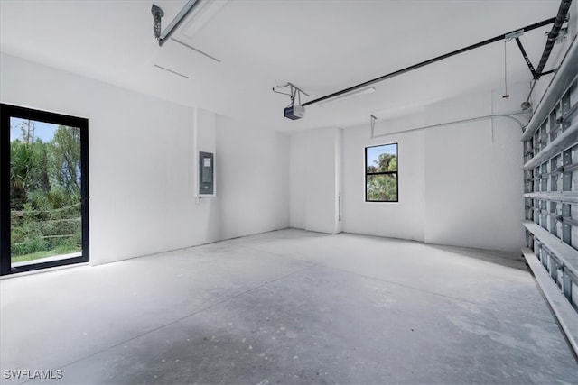 garage with electric panel and a garage door opener