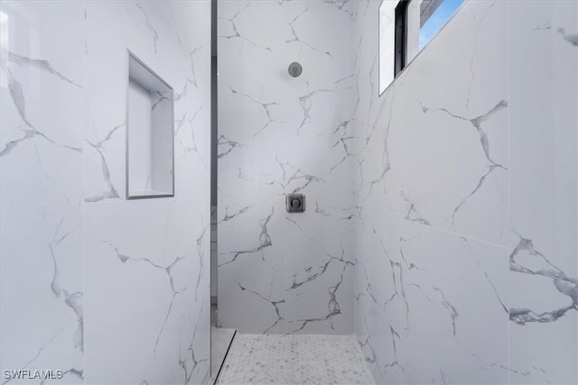 bathroom with a tile shower