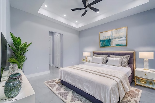 bedroom featuring a tray ceiling and ceiling fan