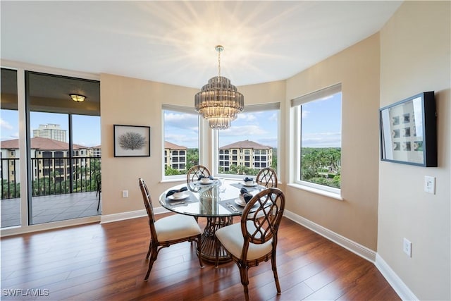 23540 Via Veneto Blvd Unit 605, Estero, FL 34134 - dining space featuring a chandelier, dark wood-style flooring, and baseboards