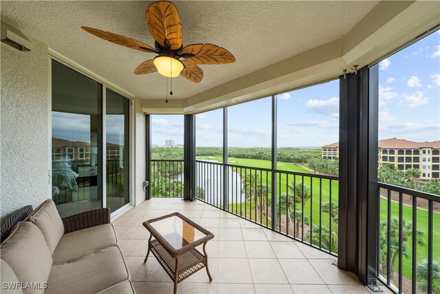 23540 Via Veneto Blvd Unit 605, Estero, FL 34134 - sunroom with a textured ceiling, tile patterned floors, a textured wall, and a water view
