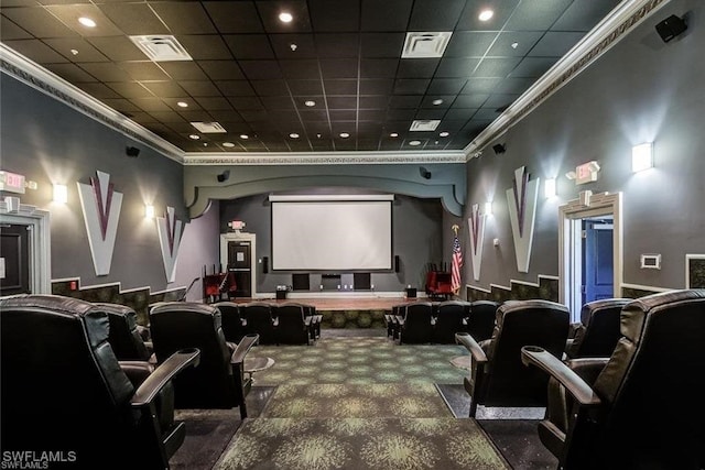 home theater room featuring a paneled ceiling, carpet floors, and ornamental molding