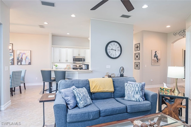 tiled living room featuring ceiling fan