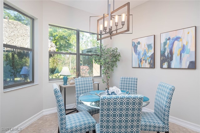 dining space featuring light tile patterned floors and an inviting chandelier