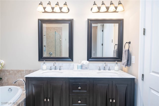 bathroom with vanity and a relaxing tiled tub