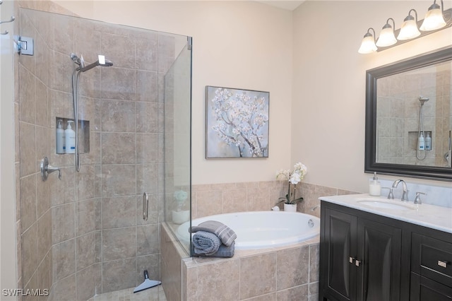 bathroom featuring vanity and independent shower and bath