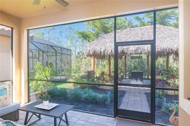 sunroom / solarium featuring ceiling fan and a healthy amount of sunlight