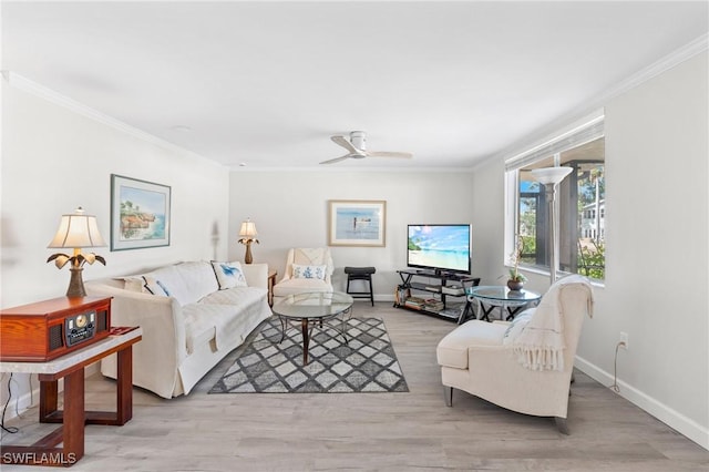 living room featuring light hardwood / wood-style flooring, ceiling fan, and ornamental molding