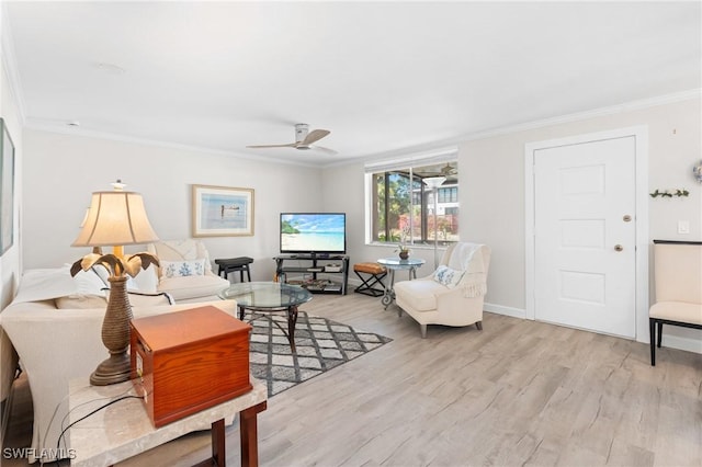 living room featuring ceiling fan, light wood-type flooring, and ornamental molding