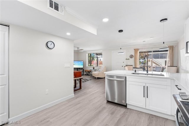 kitchen with pendant lighting, white cabinets, sink, light hardwood / wood-style flooring, and appliances with stainless steel finishes