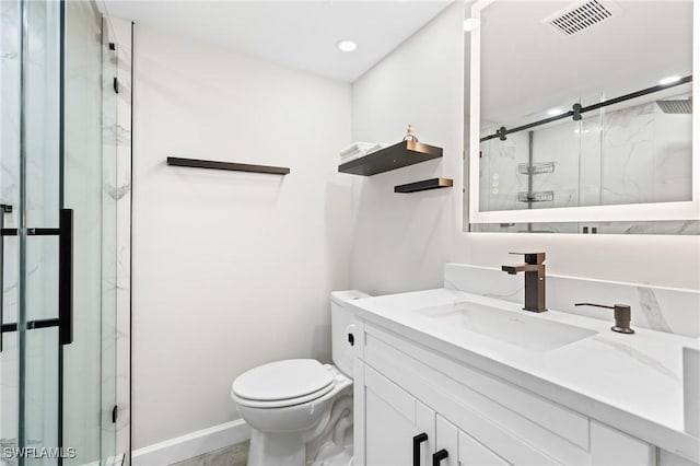 bathroom featuring vanity, toilet, and an enclosed shower