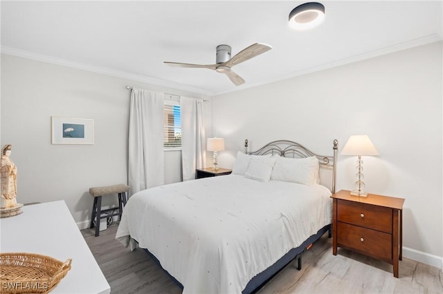 bedroom featuring ceiling fan, wood-type flooring, and crown molding