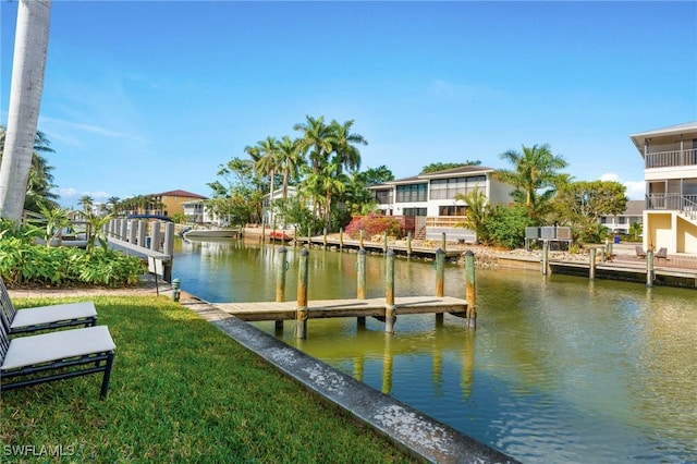 dock area with a yard and a water view