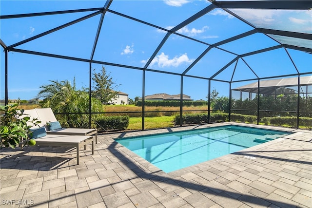 view of pool featuring a patio area and glass enclosure