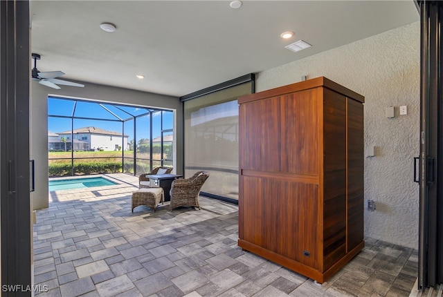 interior space featuring ceiling fan and a swimming pool