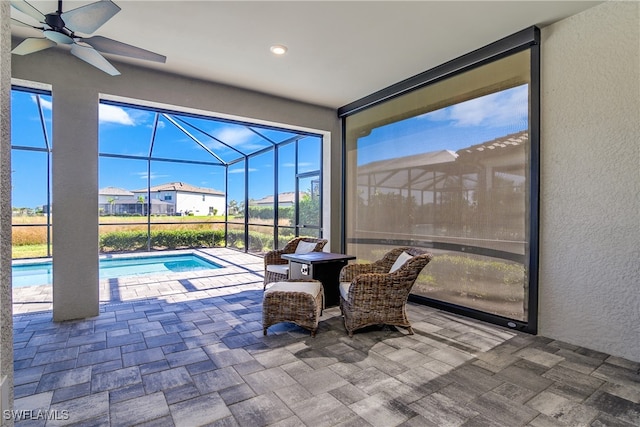 interior space with ceiling fan