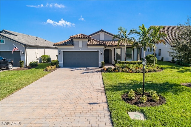 mediterranean / spanish house featuring a garage and a front lawn