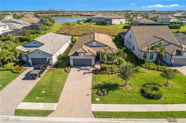 birds eye view of property with a water view